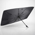 Black umbrella-style car windshield sun shade designed to block heat and protect dashboard from sunlight glare.
